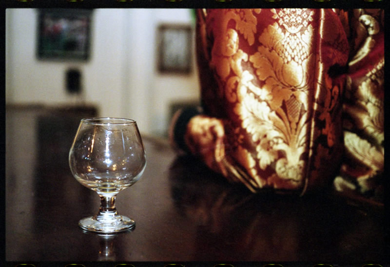 Whiskey Sifting in a Black Reversible Smoking Jacket