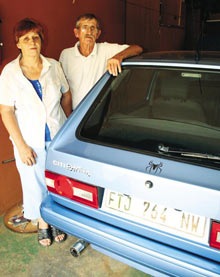 [Jordaan_Mike_Lettie_WithCar_TheirSonWasMurderedIn.jpg]