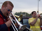 Photo: Andy, Mike, and Rob play their horns for the crowd in the parking lot.