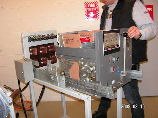 Racking the breaker onto the test cart.