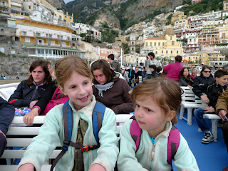 The ferry sways hard, and Lily listens to Emma for reassurance.