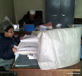 A government office in Afghanistan with an unused computer screen and paper records.