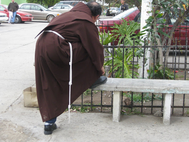 A monk trying his shoe.