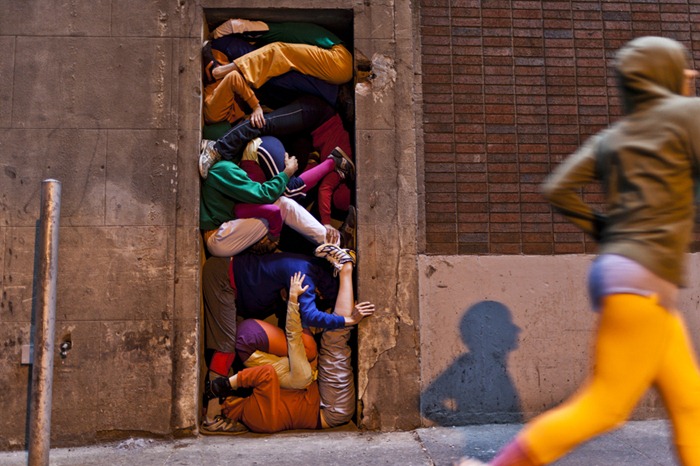 Performers situate themselves into position during a piece entitled "Bodies in Urban Spaces" by choreographer Willi Dorner.  Starting at sunrise, the performers inched their way into different spaces throughout lower Manhattan.

CREDIT: Bryan Derballa for The Wall Street Journal
NYBODIES