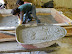 Plaster is poured until it's one inch thick in the form box
