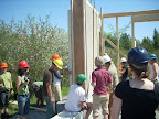 The first prefabricated straw bale wall panel is set in position