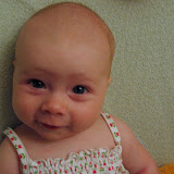 On the changing table, making faces at daddy. (July)