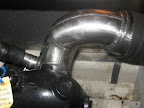 This water cooled, stainless steel exhaust riser was designed and built by National Marine Exhaust. It is an aftermarket swept style riser for a Bayliner boat powered by a 310 HP Hino engine. This swept style riser is designed to maximize the exhaust flo