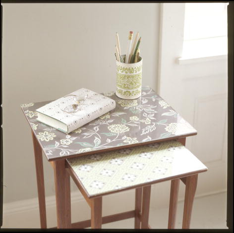 Covering an old table with wallpaper is a great way to disguise scratches. (marthastewart.com) Covering an old table with wallpaper is a great way to disguise scratches. (marthastewart.com)