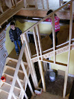 Looking down on the front stairwell through the laundry room wall