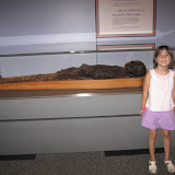 Madeline poses with the mummy at the science museum
