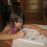 Madeline working on her Alphabet Island level 2 workbook on the first day of school. Shes working on marking words with short vowel sounds.