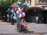 A man sells balloons on the street during the festivals of Burgos.