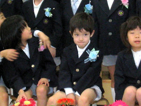 Kai waiting for the group photo to be taken at his kindergarten graduation