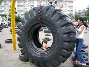 Kai in the biggest tire at the park