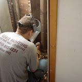 Jimmy cutting the cracked section of the pipe in the living room