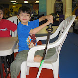 Kai shows off the frosting on the sword after cutting his cake with it