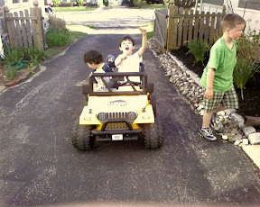 Kai and Eidan riding on the neighbor's battery powered mini Jeep Kai and Eidan riding on the neighbor's battery powered mini Jeep