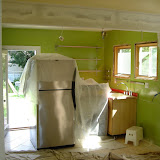 The wall between the kitchen and dining room is gone, with a new 12 inch header along the ceiling where it was (already drywalled in this picture)