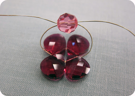 step 4: with both ends of the wire, criss-cross through 10 mm round crystal.