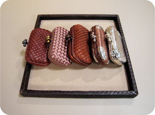 a selection of clutches. all woven in different materials.Check out the tray's edge– it's woven too!