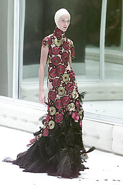Dress of nude silk appliqued with roundels in the shape of chrysanthemums embroidered with red, gold, and black silk thread with black ostrich feathers (VOSS - Spring/Summer 2001) Dress of nude silk appliqued with roundels in the shape of chrysanthemums embroidered with red, gold, and black silk thread with black ostrich feathers (VOSS - Spring/Summer 2001)
