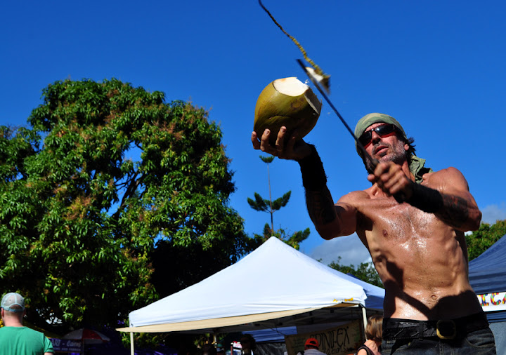 7/11/2010-Coconut Phil prepares one of his handpicked coconuts to be drank by one of his many spectators.