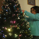 Taking great care to hang the ornaments
