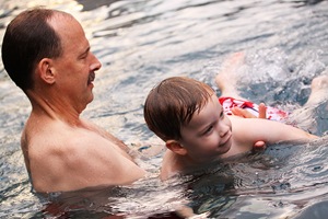 Granddaddy giving Jackson swimming instruction