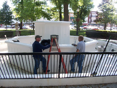 City Workers remove leaves, sticks and other debris as they prepare to paint the Central Park Fountain in Downtown Washington City Workers remove leaves, sticks and other debris as they prepare to paint the Central Park Fountain in Downtown Washington