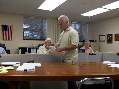 Washington County Conservation Director Steve Anderson distributes his agency's annual report to the Board of Supervisors