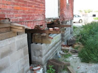 The back wall of the building is in very poor condition.  There are many missing bricks and voids in the mortar.<br />
(Washington City Hall)