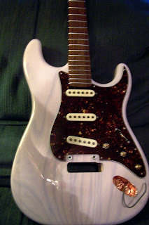 After the pickguard and neck are attached.  Still have to finish up the input jack at this point.  Not the best photo, sorry.