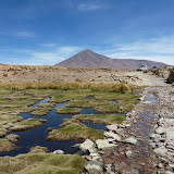 Volcano overlooking a dusty plains and blue marshes