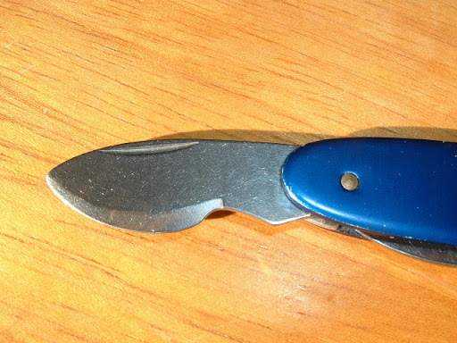 Close-up shot of the watch case opener blade on this Wenger watch case knife 