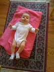 Strange picture...Audrey looks like a little baby weightlifter. This is a onesie which is also a turtleneck. But it also makes it looks like she has no neck. For a baby, she's very strong...but I don't think we're heading in the direction of weightlifter. I could be wrong though.