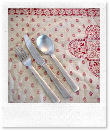 fork, knife, spoon on red patterned cloth