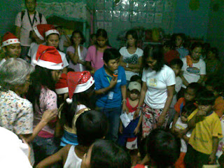 Day Care Center Teacher Gina Ballatan calls the names of the recipients of the toys.
