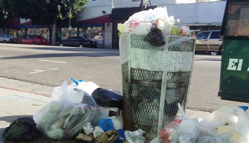 Another trash can is also overflowing in plain sight one block west at 