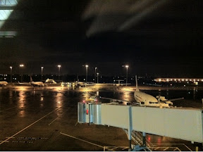 an airport at night with airplanes on the ground