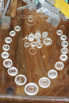 Layout of necklace to determine how many handmade small square wire jump rings to create