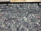 Stock of large diameter black hard rubber.