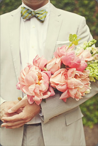  a groom holds his bride 39s arm bouquet of peonies romantic 