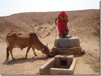 Woman drawing water from her Beri