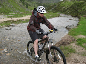 another stream.  it started lightly raining on us. at one point, todd realized there were tadpoles in our biking trail.