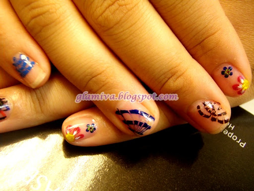 red yellow and blue flowers nail art design with butterfly wings