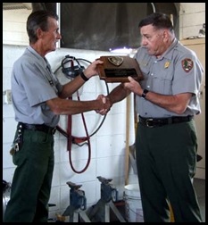 ed_Larry receives plaque from Superintendent John Benjamin