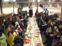 children being fed in the school