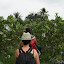 Lynette walking through said orchards, with its fruit individually wrapped in plastic bags to make it more... fruity.