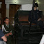 Our guide at the Police museum, standing next to a manequin of the first Columbian police officer and his “car”, around 1914.